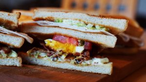 A sandwich on a wooden platter